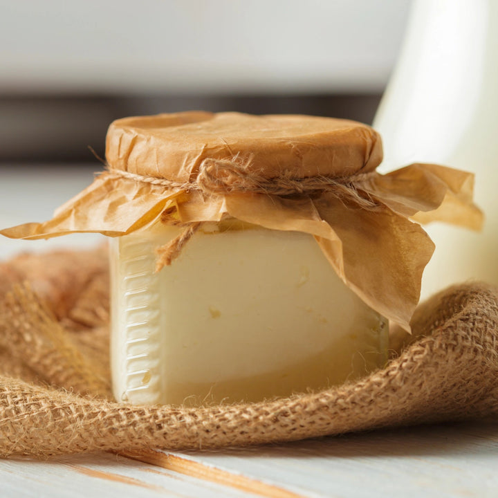Jar of Lemmon cheese wrapped in burlap on a light surface